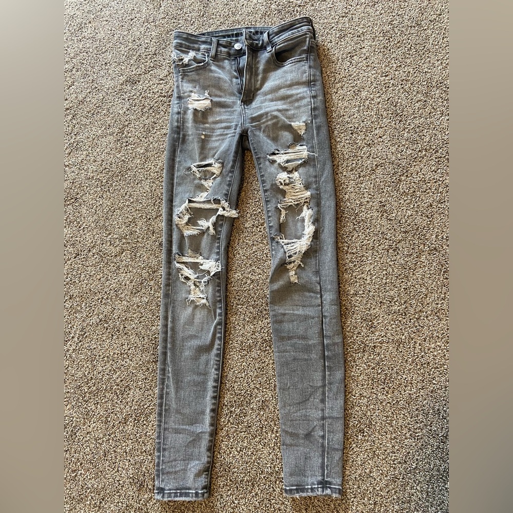 Gray ripped American Eagle Ne(x)t Level Stretch Skinny Jeans